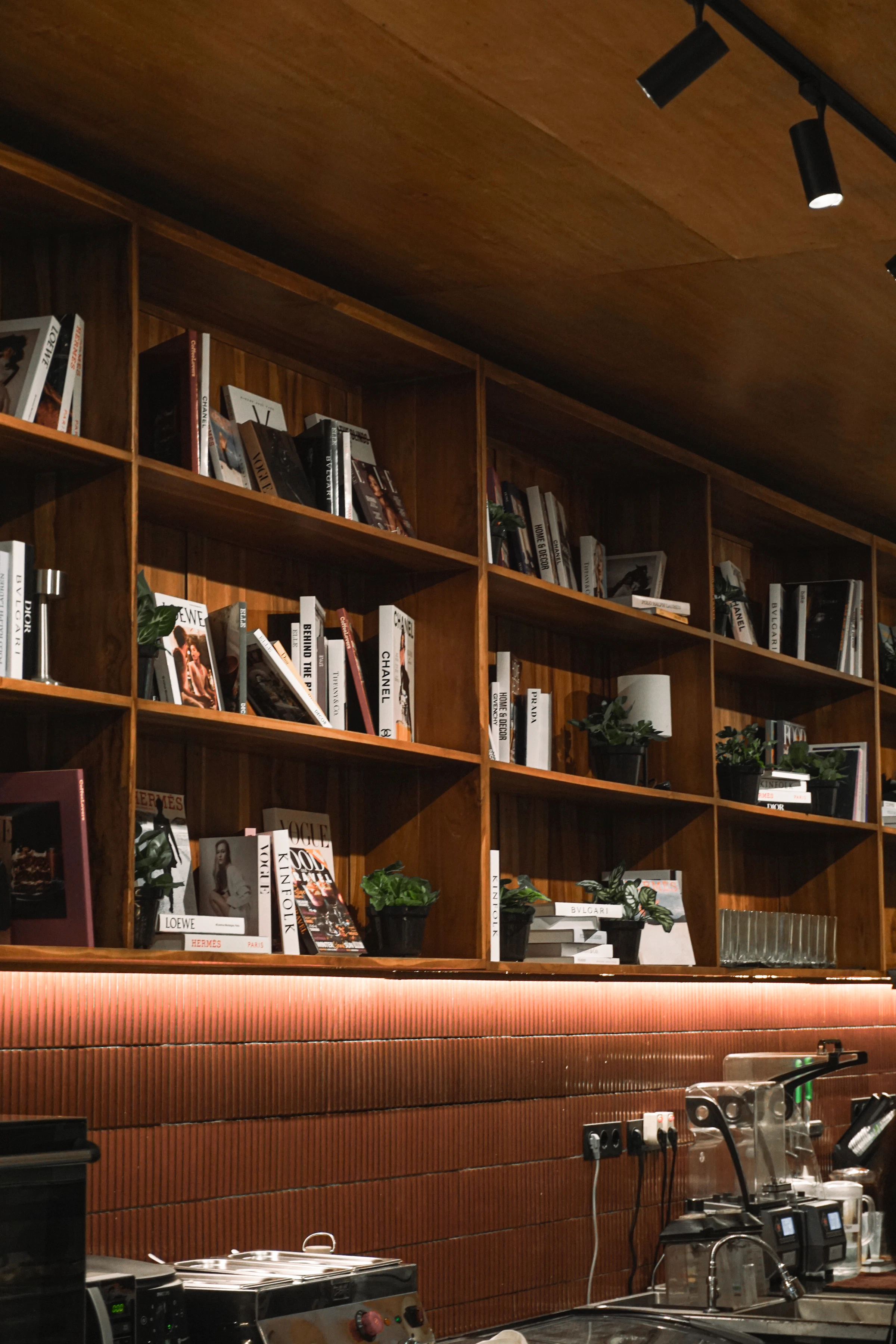 A quiet study with timber shelving and warm light